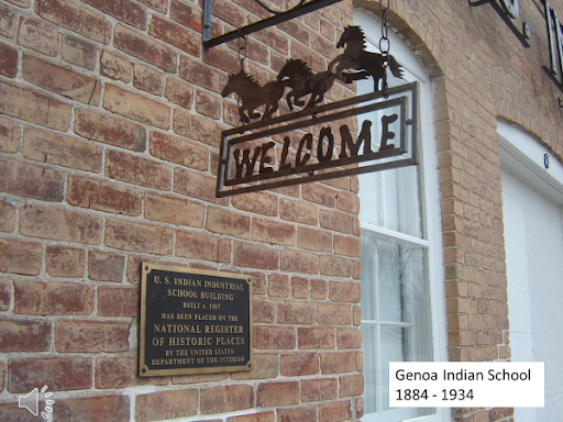 Photo of welcome sign near building entry.
